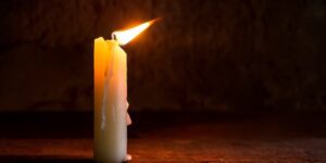 A lit candle in the breeze.